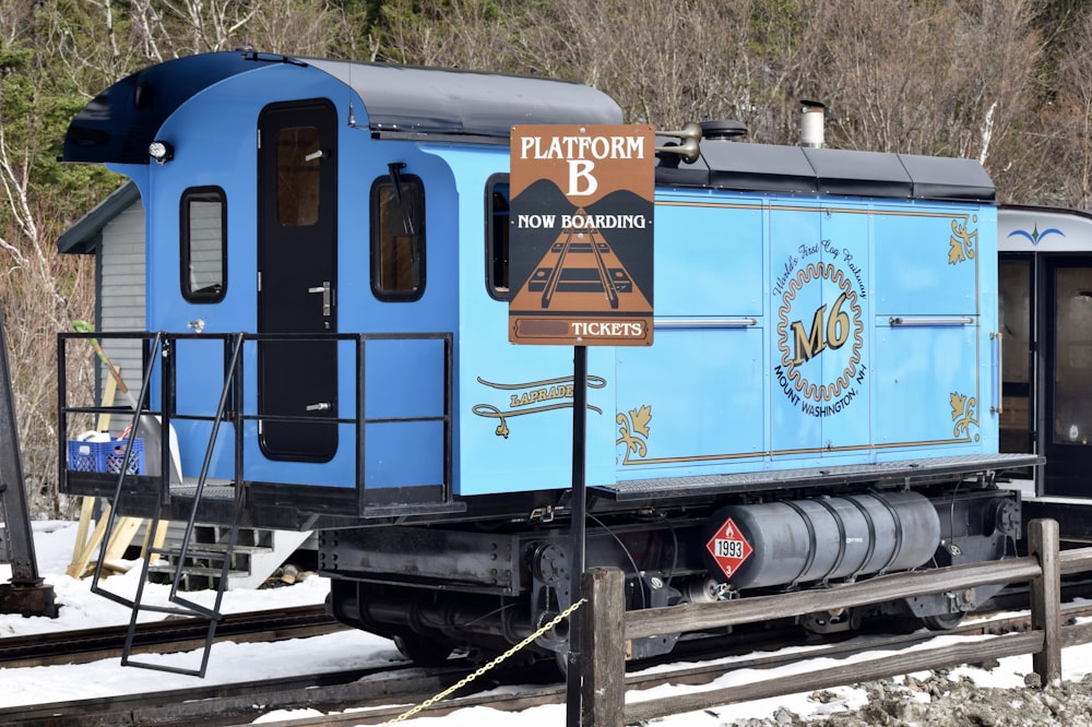a blue train on the tracks