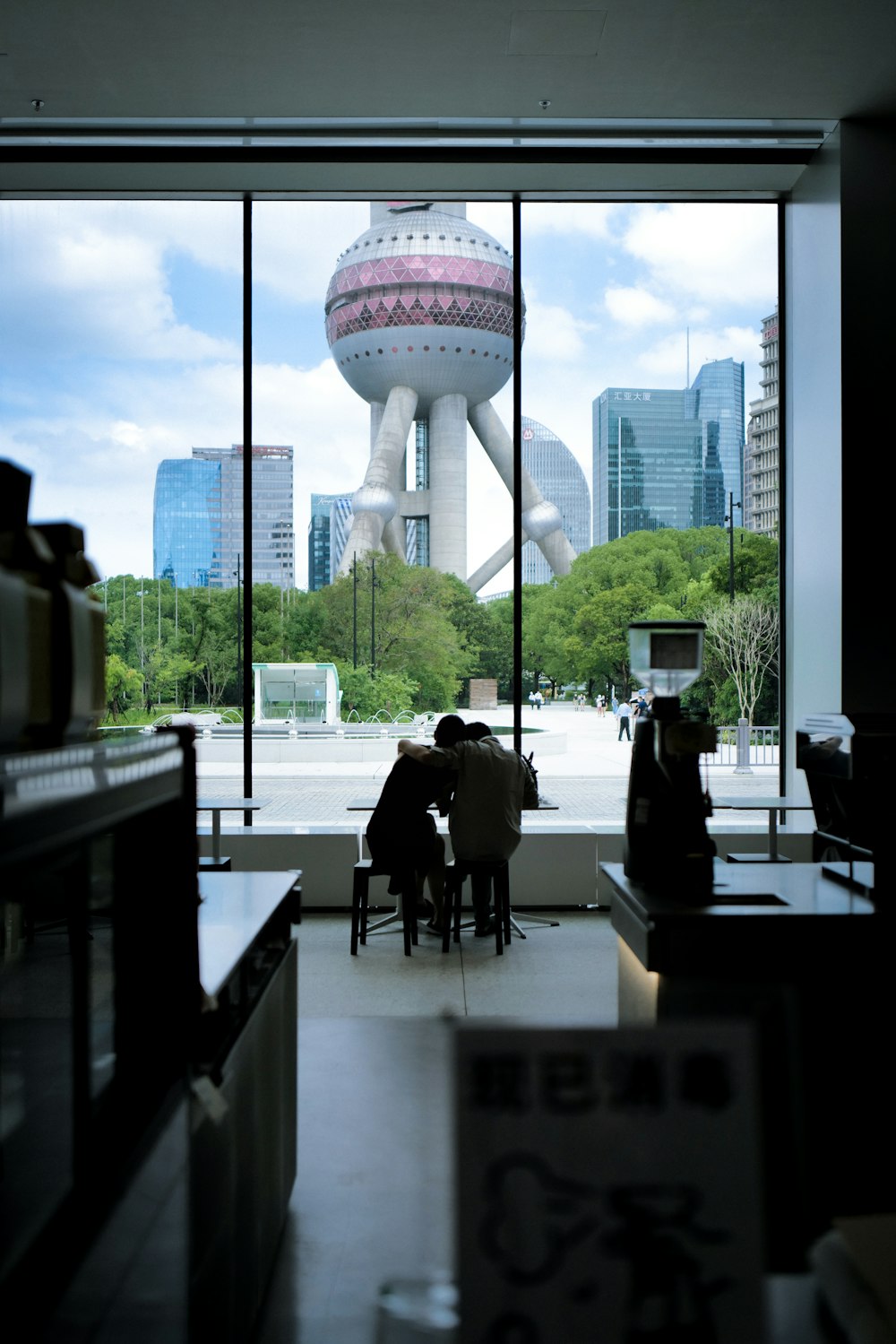 a group of people sitting at a table in front of a window