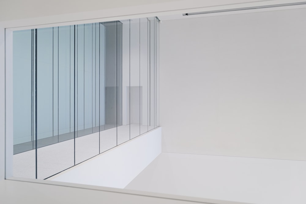 a white wall with a glass door