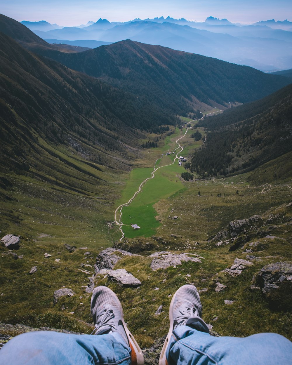 a person's feet on a mountain top