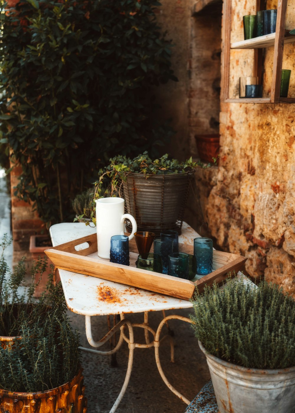 a table with a few mugs and plants on it