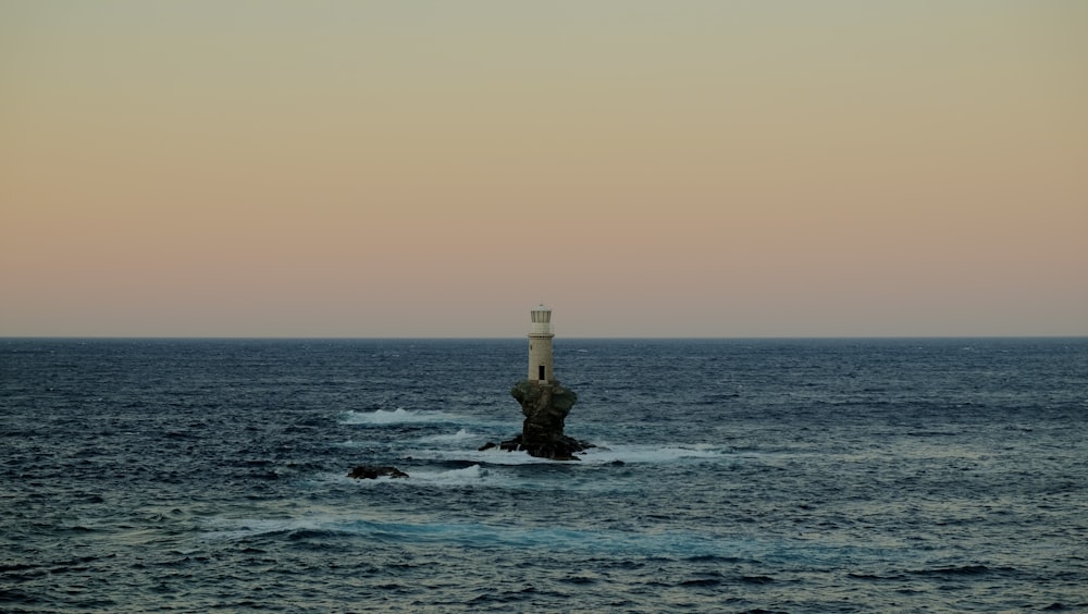 a lighthouse in the middle of the ocean