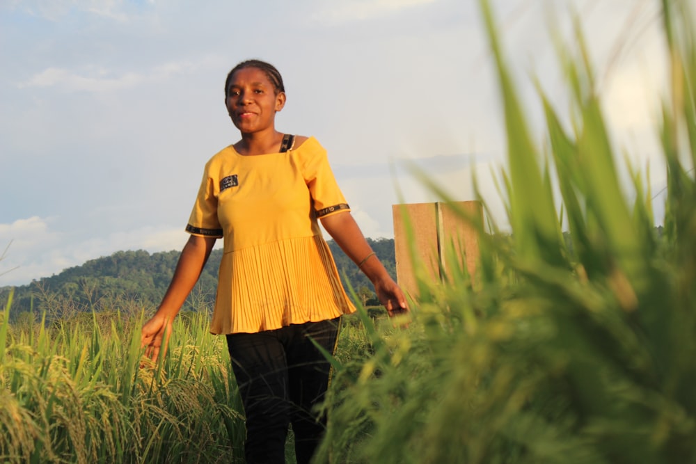 a man walking through tall grass