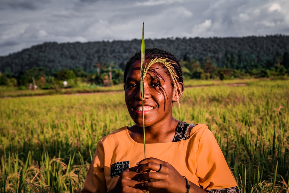 a man with a large green leaf on his head