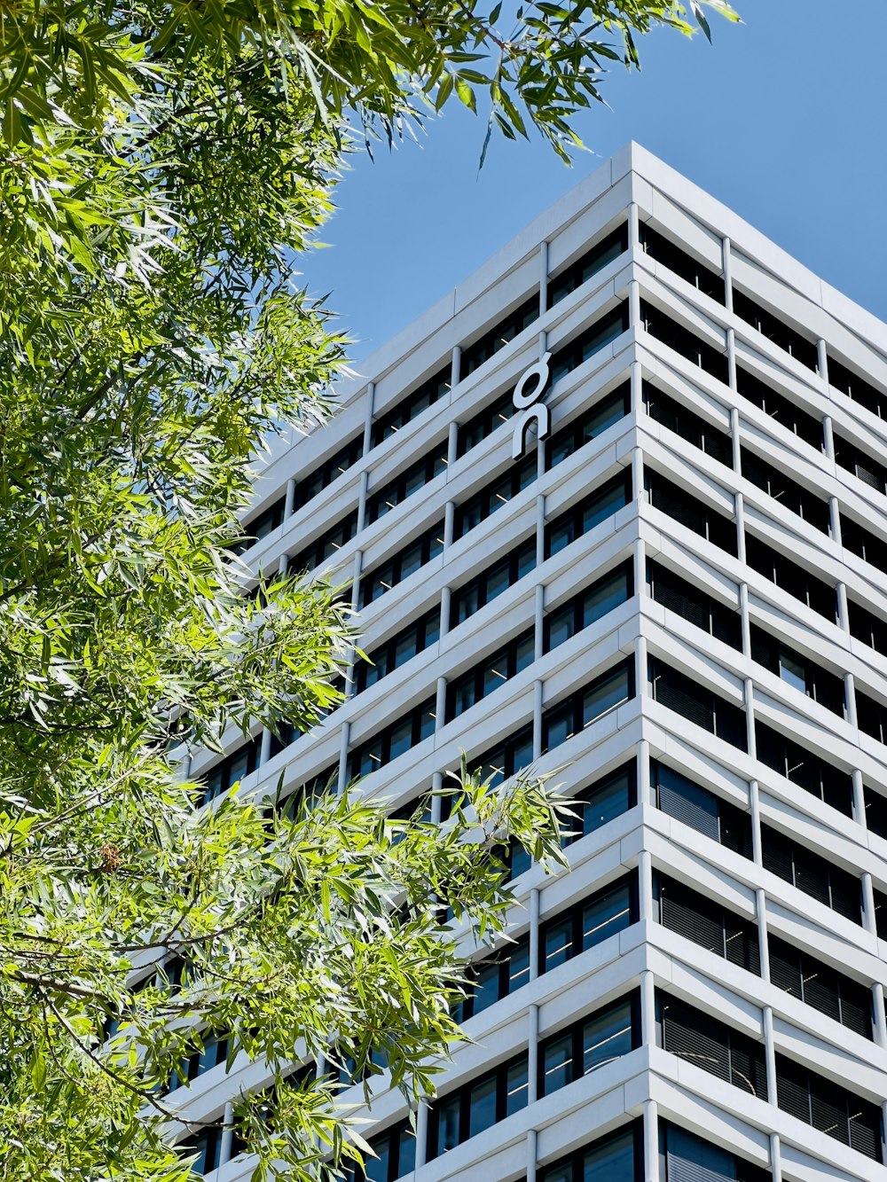 a tall building with trees in front of it