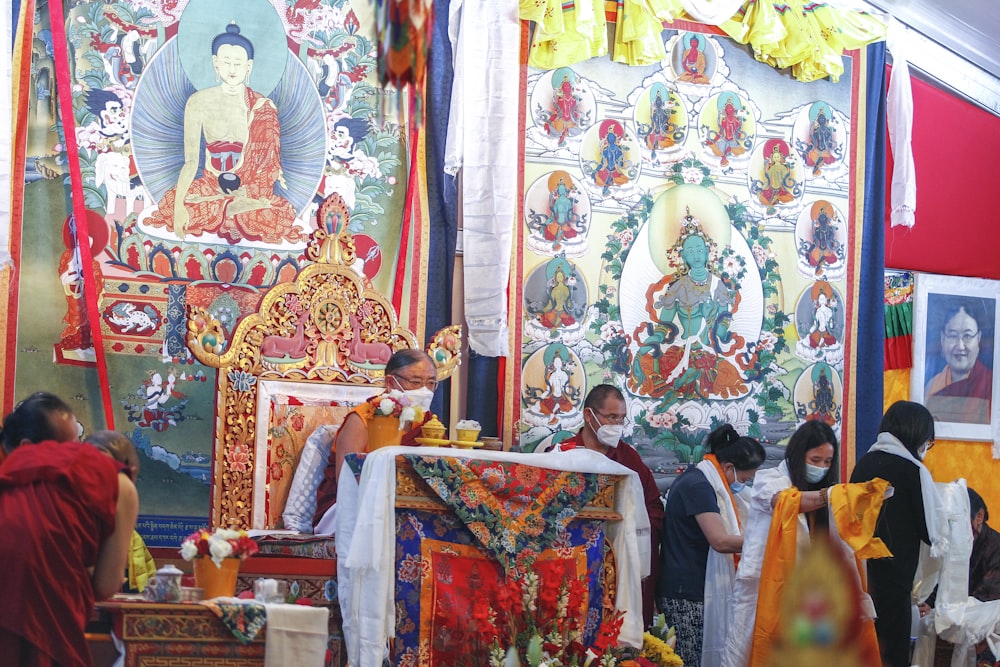 a group of people standing next to a shrine