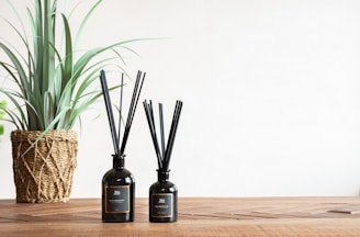 a bottle of oil next to a plant