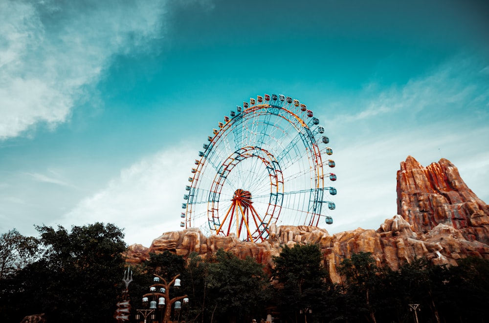 a ferris wheel on a rocky hill