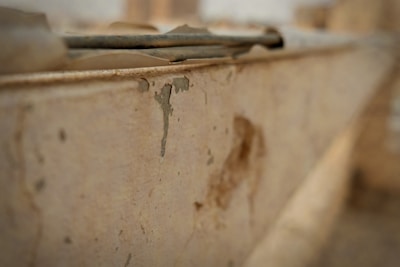 Close-up of a building corner showing cracks and wear for dilapidation assessment.