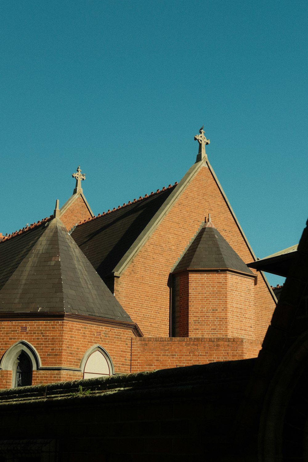 a brick building with a cross on top