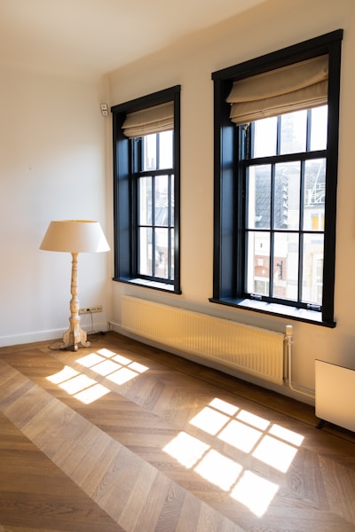 a room with a lamp and a window