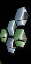 Shelves filled with multicolored 3D printed products glowing under warm lighting.