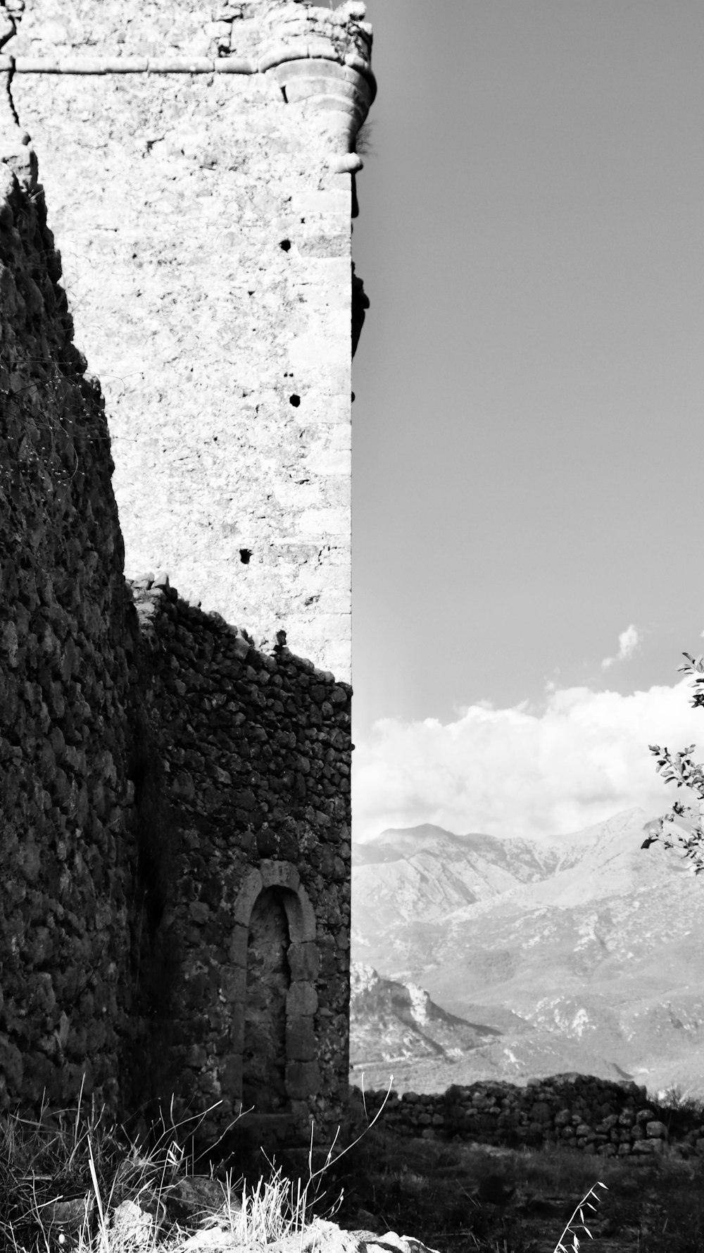 a stone archway with a mountain in the background