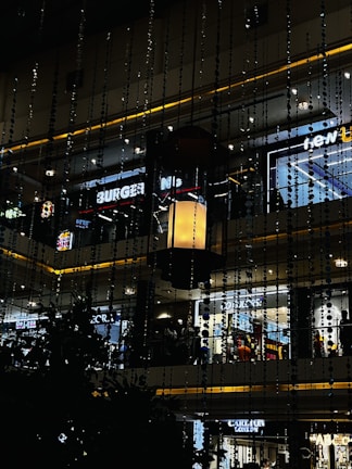 A vibrant mall branding installation featuring colorful vinyl prints and glow sign boxes.