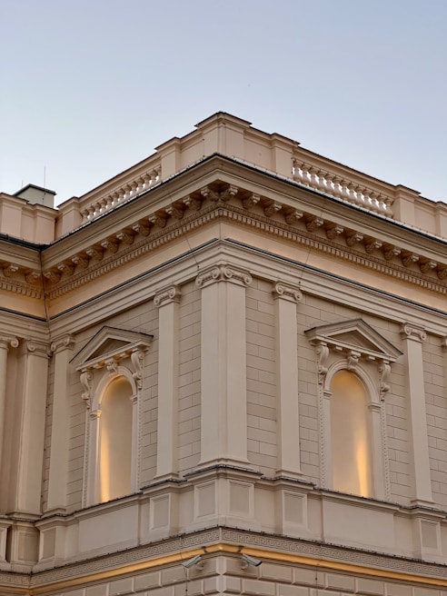 Architectural detail of a classical building facade in midnight blue tones