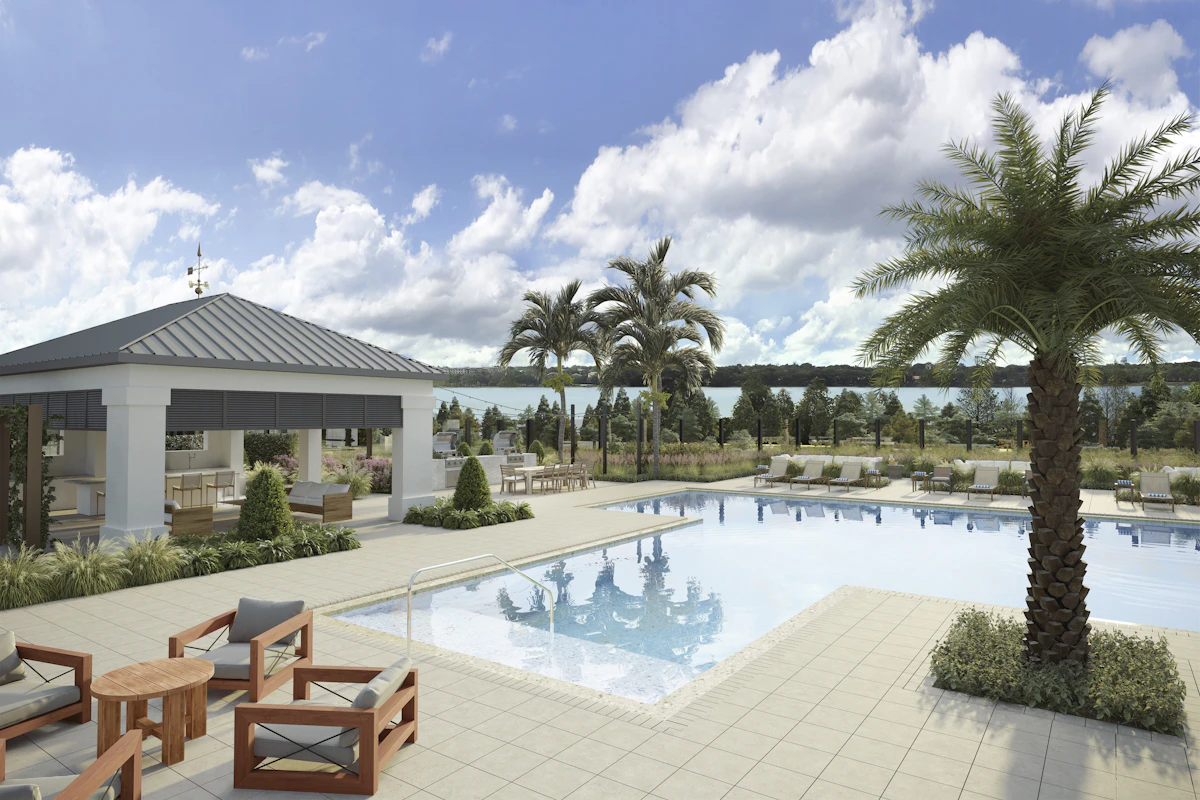 Sunny resort pool deck with lounge chairs and palm trees