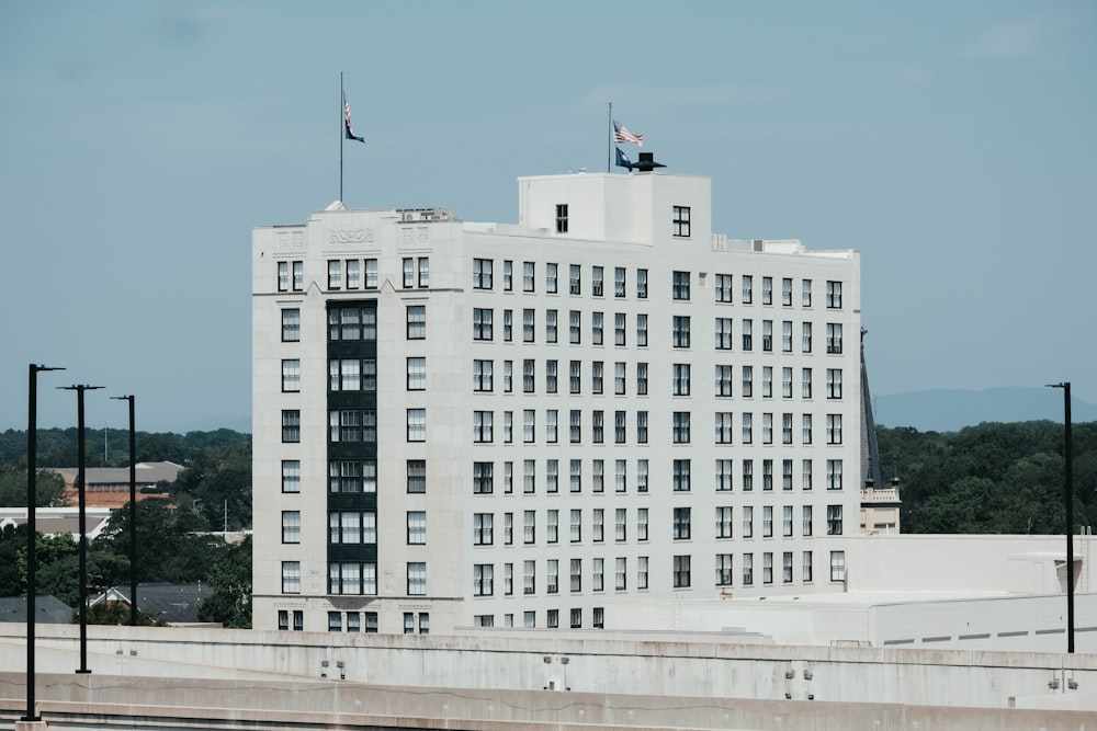 a large white building with flags on top
