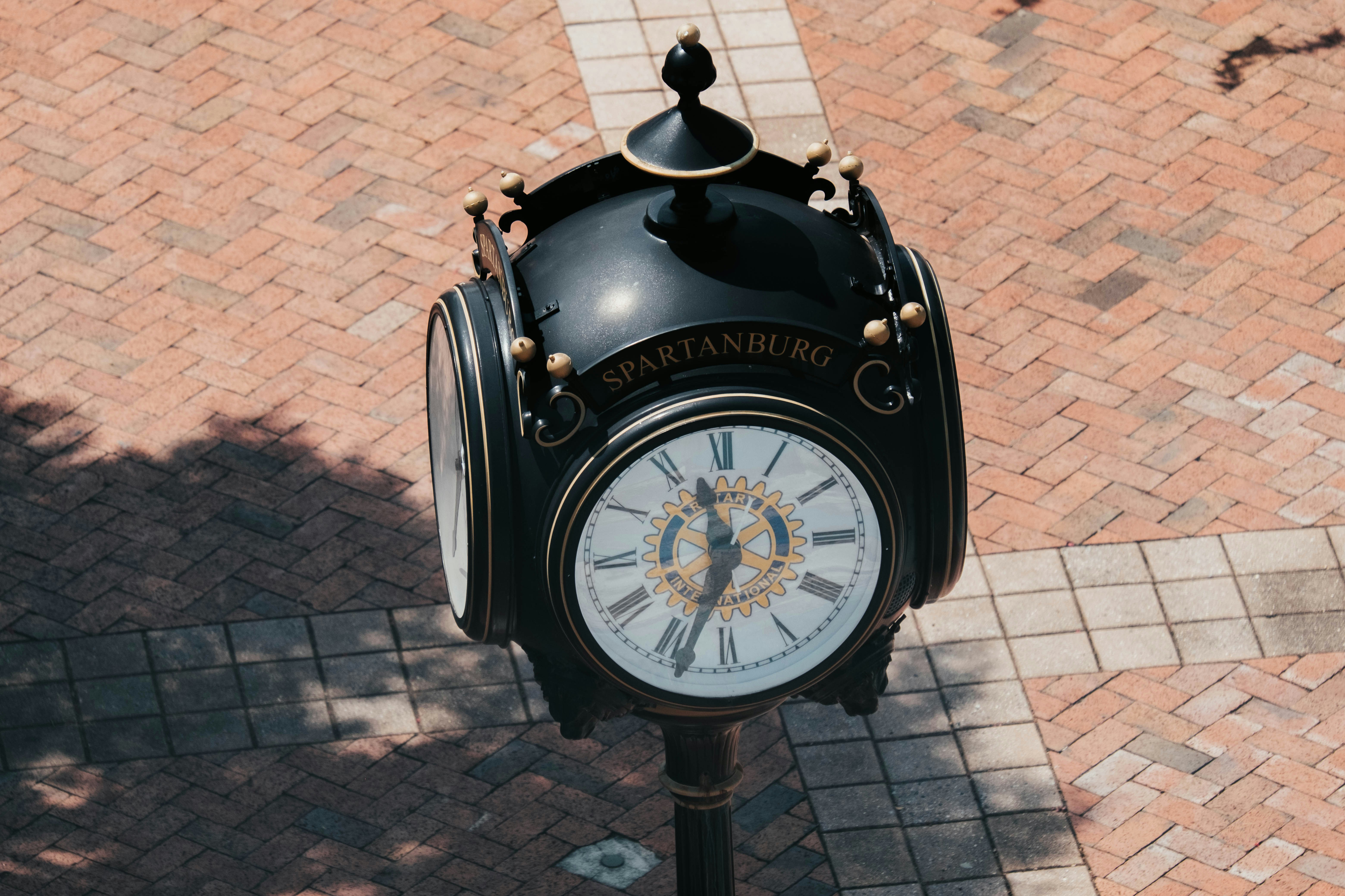 a clock on a sidewalk