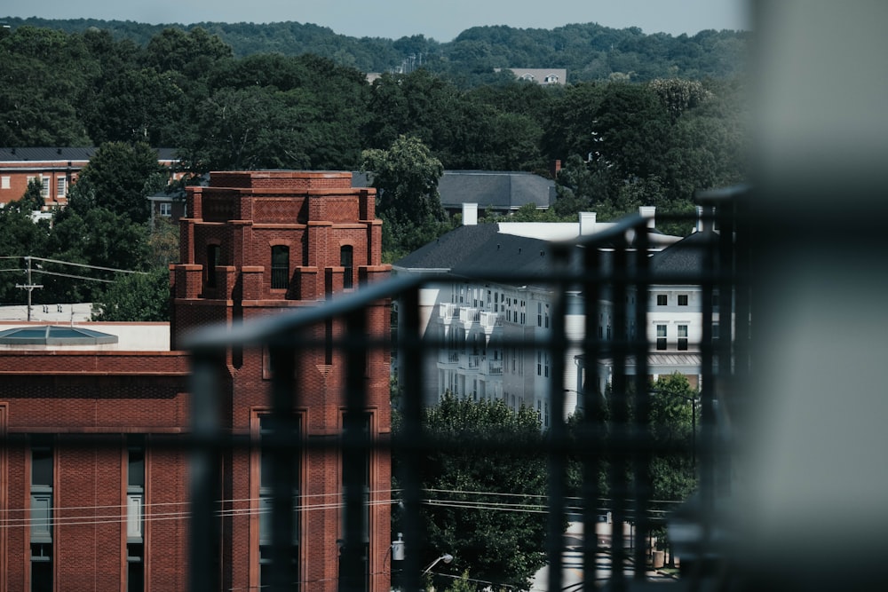 a building with a red roof and a body of water in the front