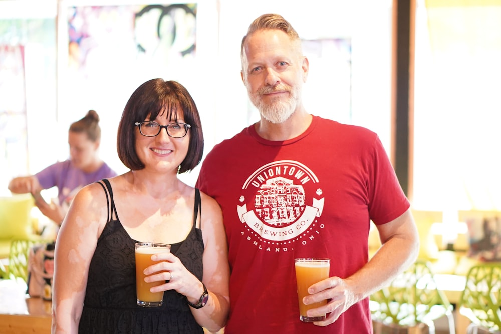 a man and woman holding drinks