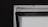 A close-up view of a window frame against a dark wall. The window appears to be slightly open with visible details of its structure, including the frame and hinges. The lighting creates a contrast between the bright window and the dark surrounding wall.