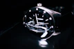 A close-up of a wristwatch on a person's wrist, showing intricate craftsmanship and a modern look.