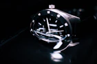 A close-up of a wristwatch on a person's wrist, showing intricate craftsmanship and a modern look.