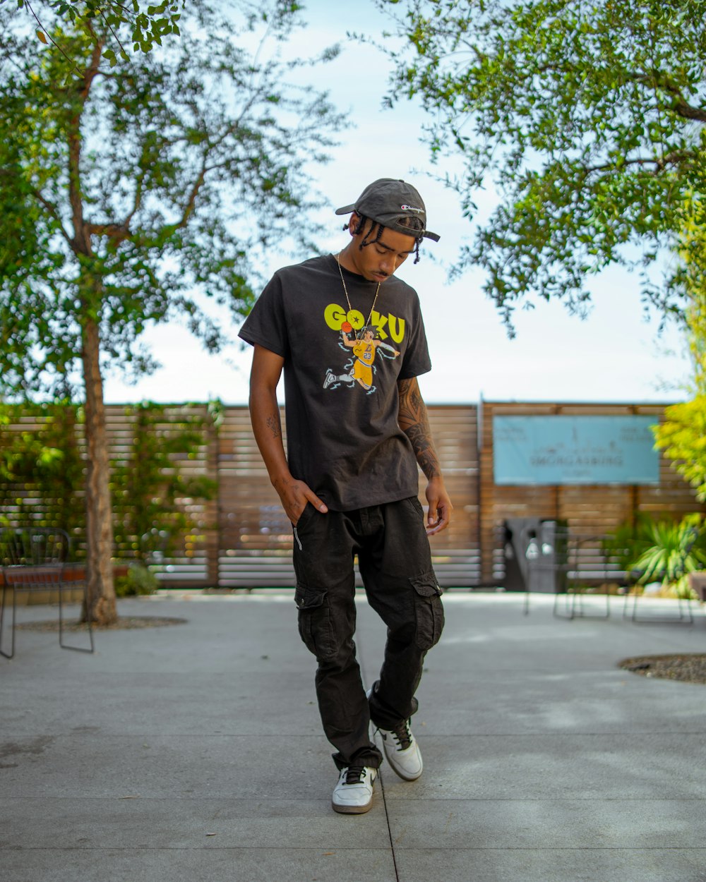 a man wearing a hat and standing outside