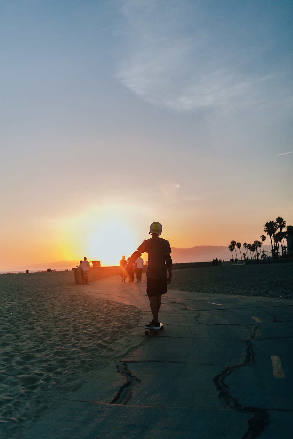 a man skateboards on a beach