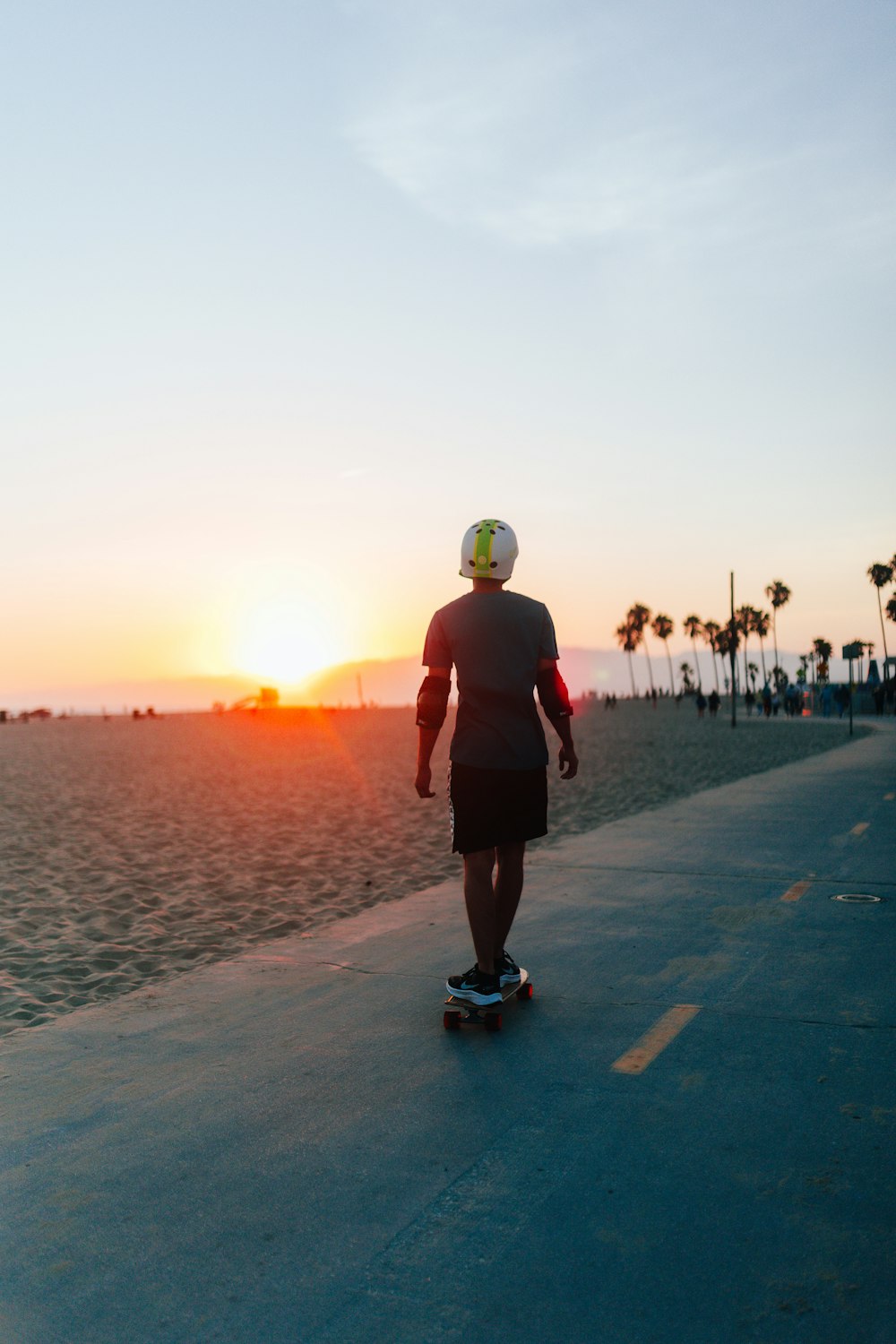 a man riding a skateboard down a road