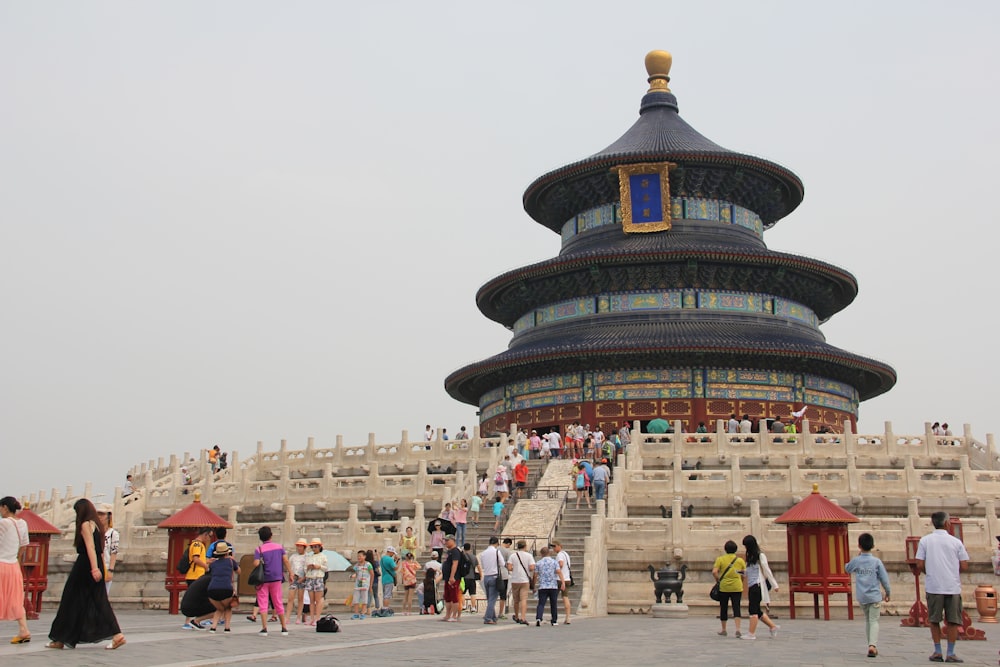 a group of people walking around Temple of Heaven