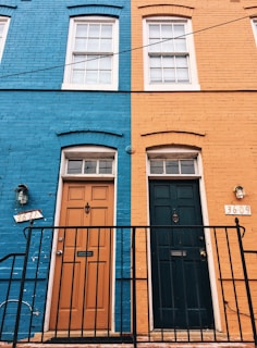 a blue building with a black door