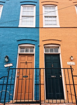 a blue building with a black door