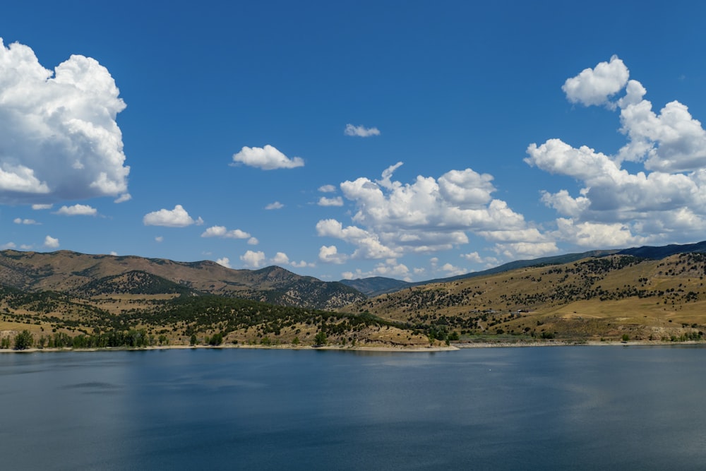 a body of water with hills in the background