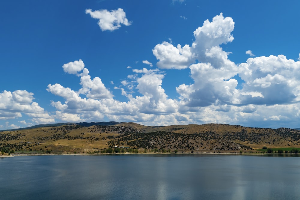 a body of water with hills in the background