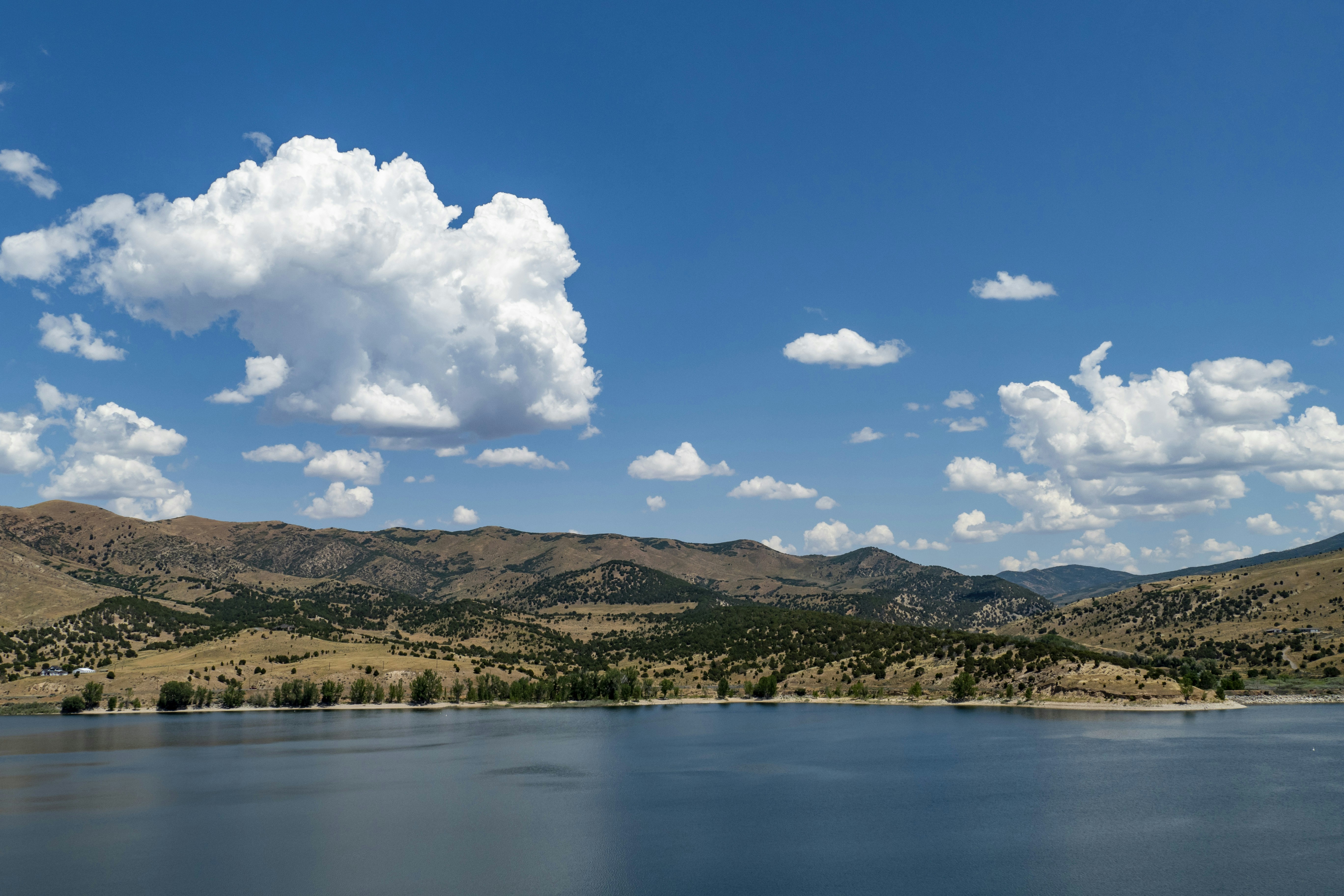a body of water with hills in the background