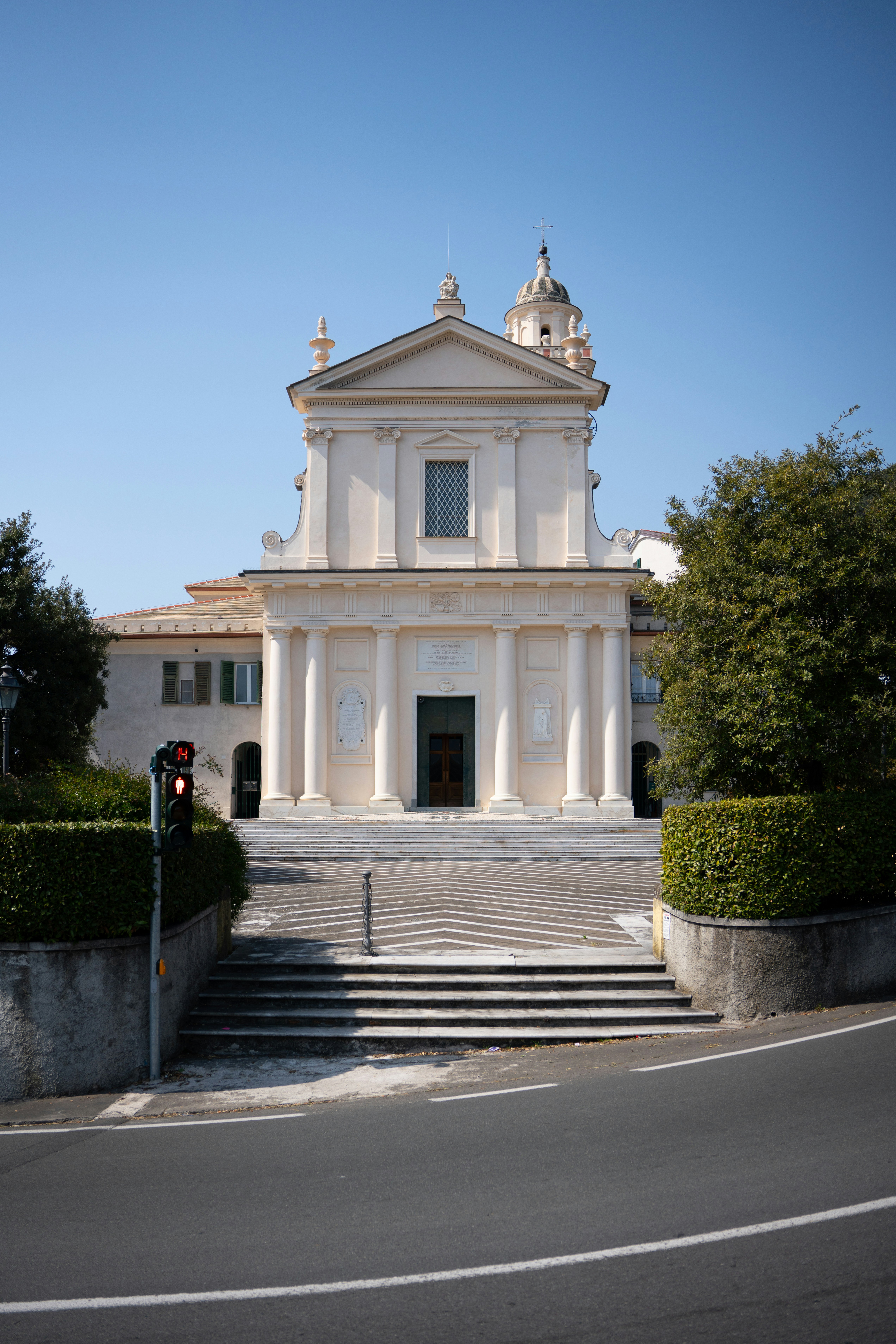 A white building with a cross on top photo Free Chiavari Image on