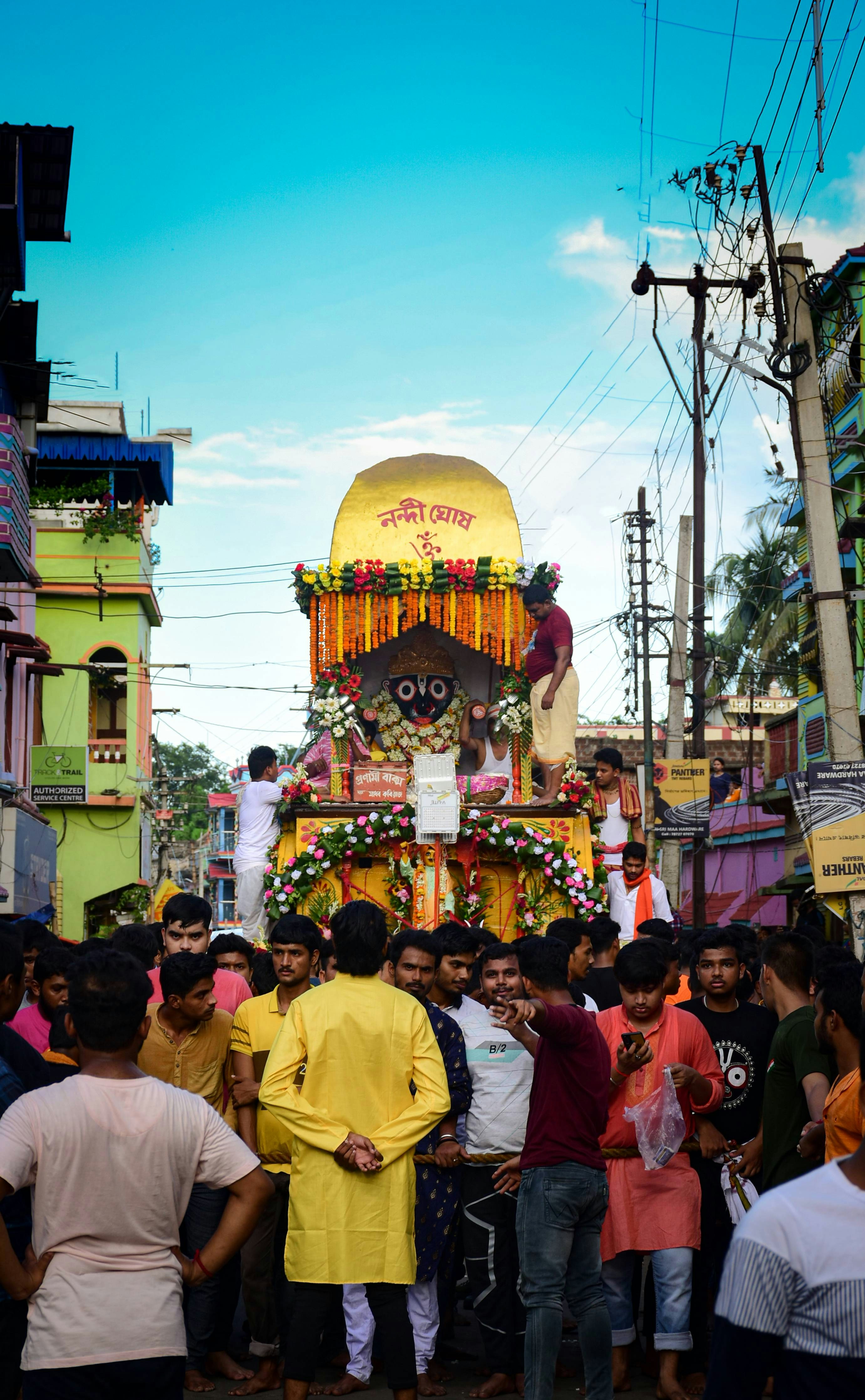 a group of people standing in front of a colorful temple