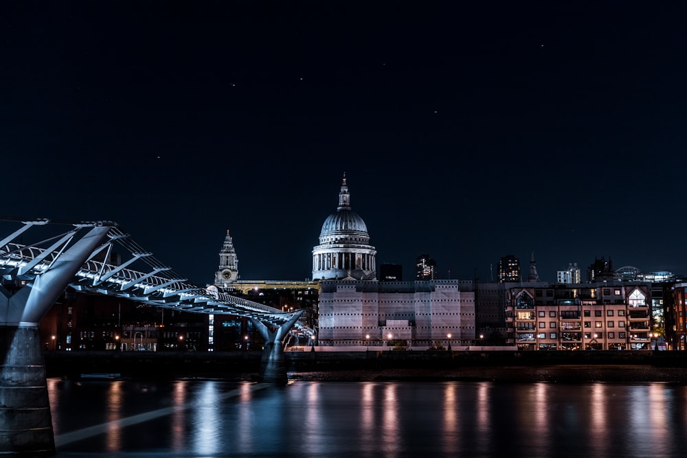 a bridge over water with buildings in the background