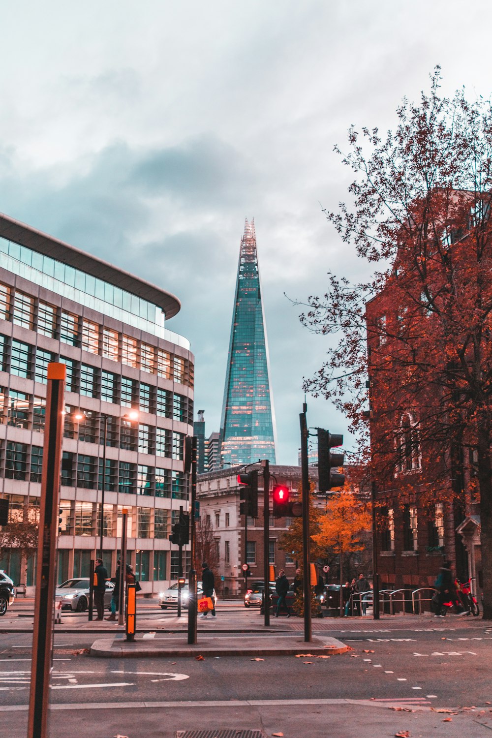 a city street with a tall building in the background