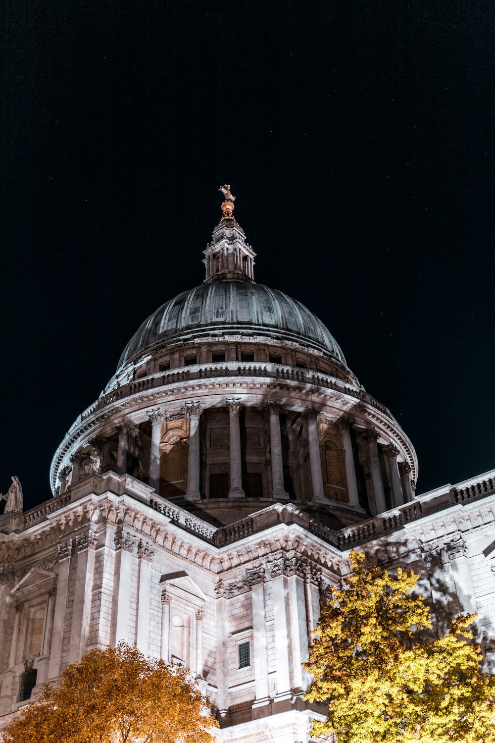 a large building with a dome and columns at night