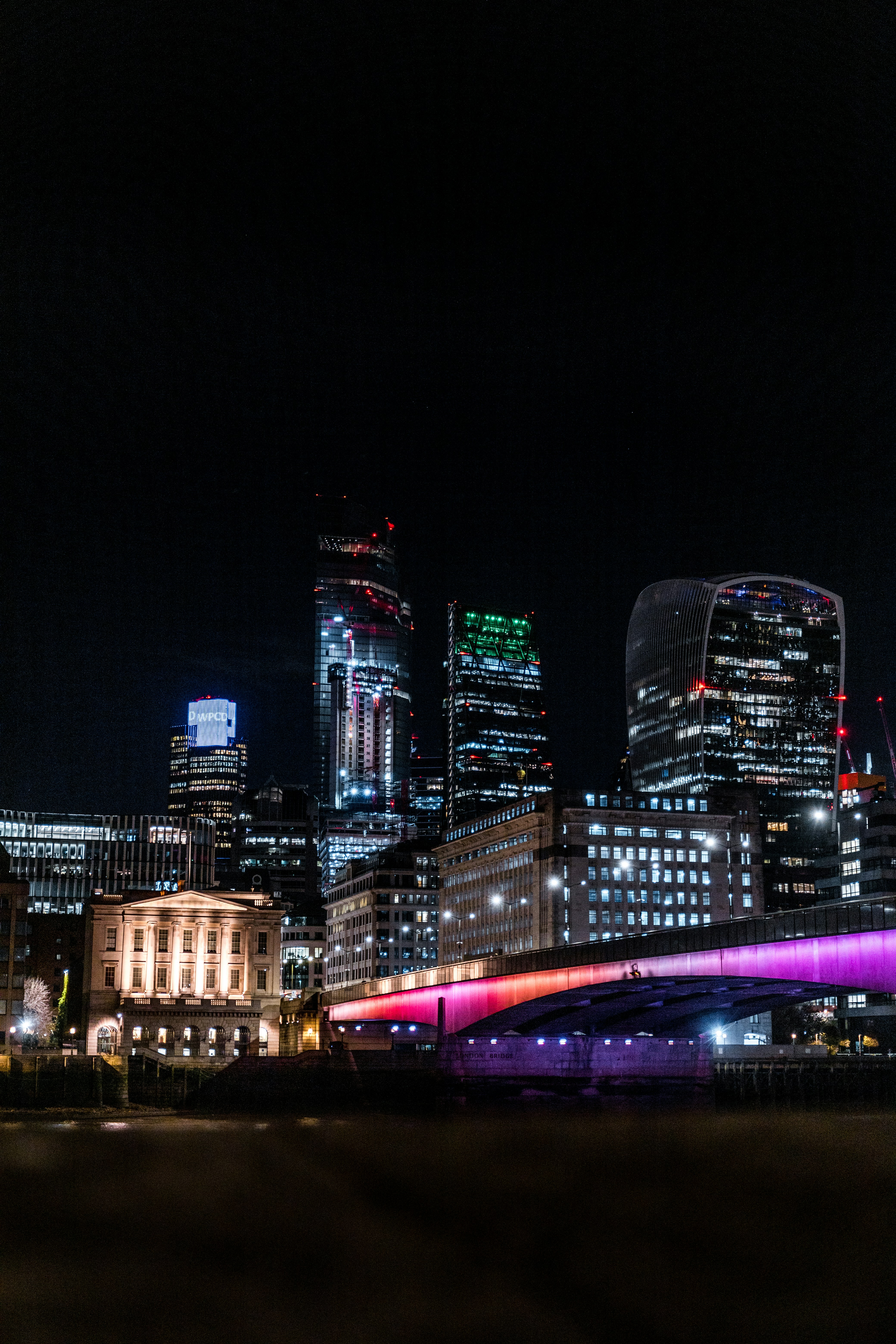a bridge over a river in a city at night