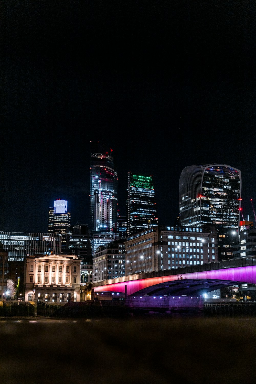 a bridge over a river in a city at night