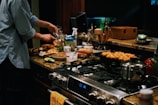 a person cooking food on a stove