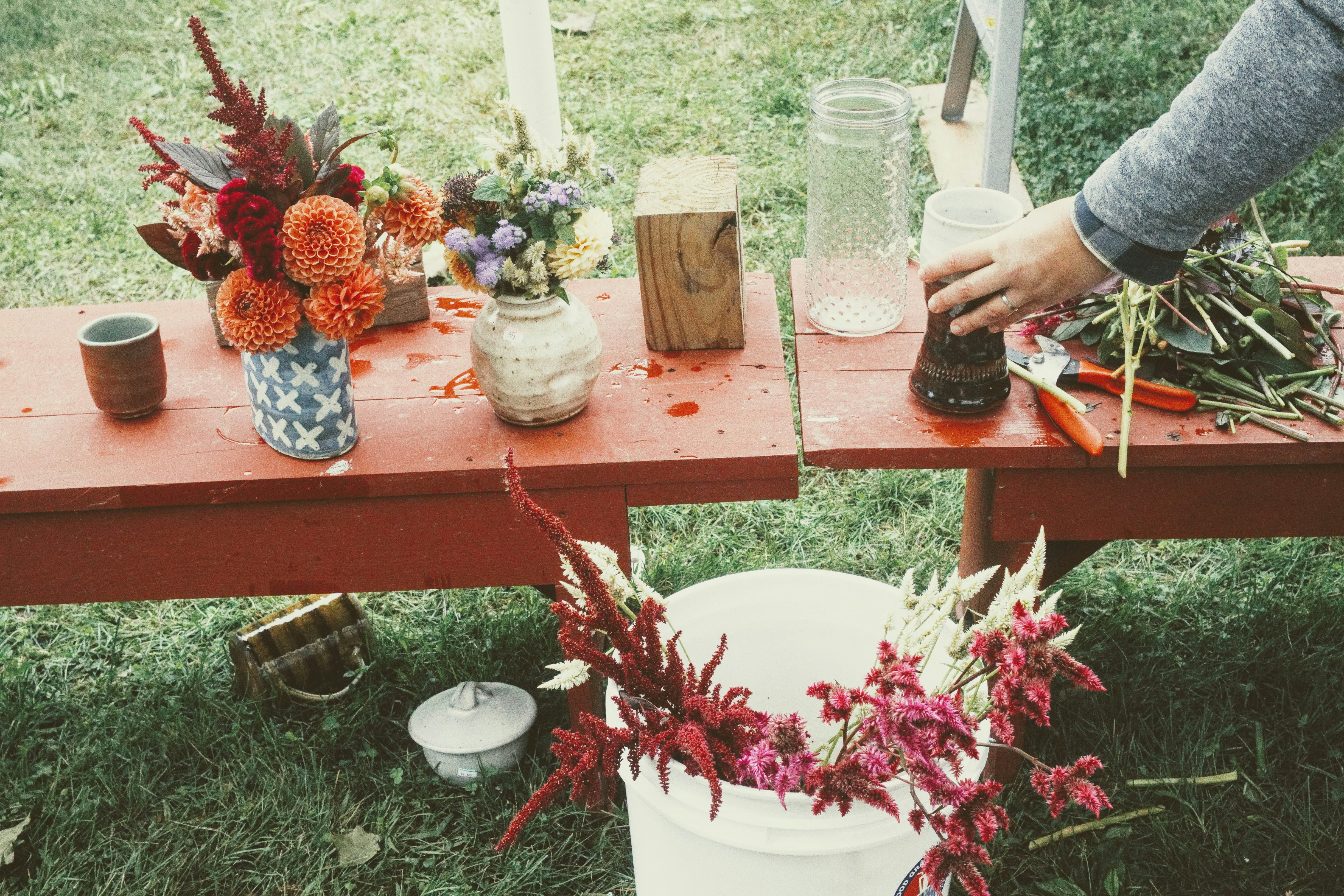 Arranging flowers on an outdoor table