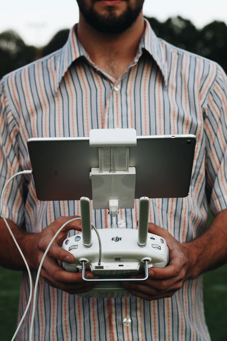 Farmer using a tablet to
    control an agricultural drone
