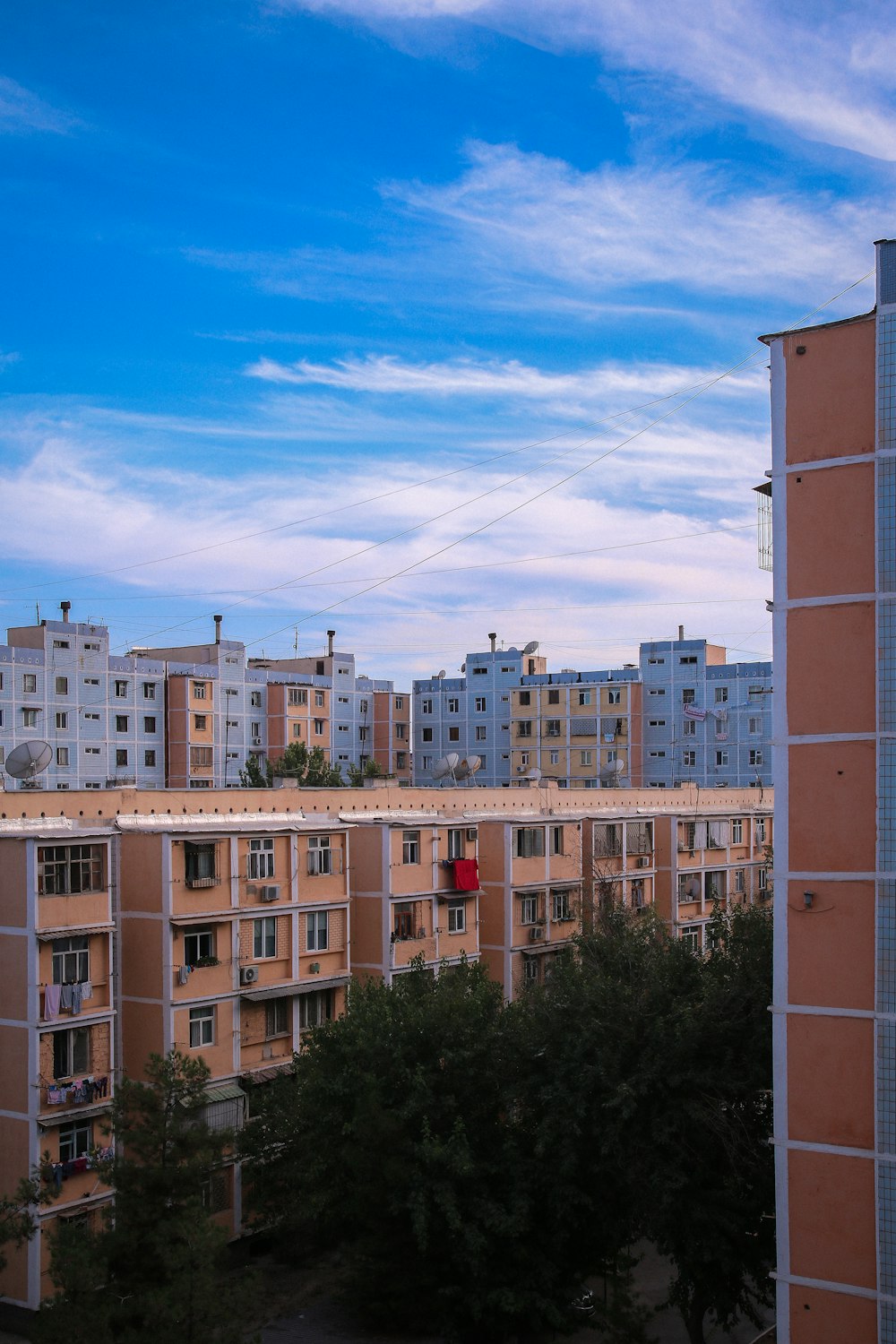 a group of buildings with trees in front of them