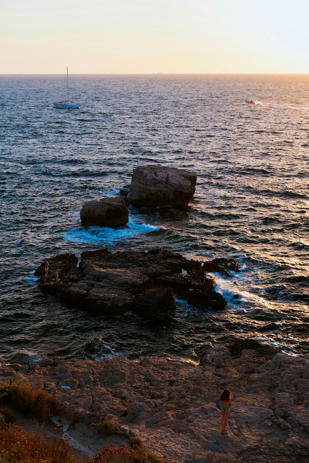 a person standing on a rocky beach