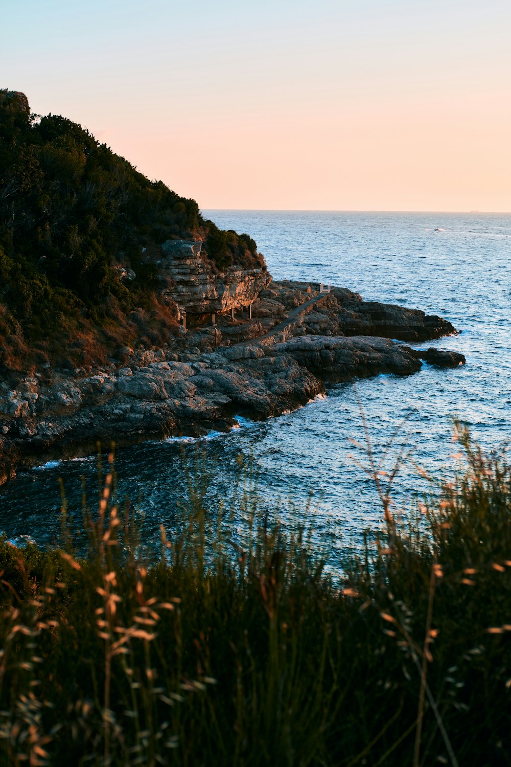 a rocky cliff next to the ocean