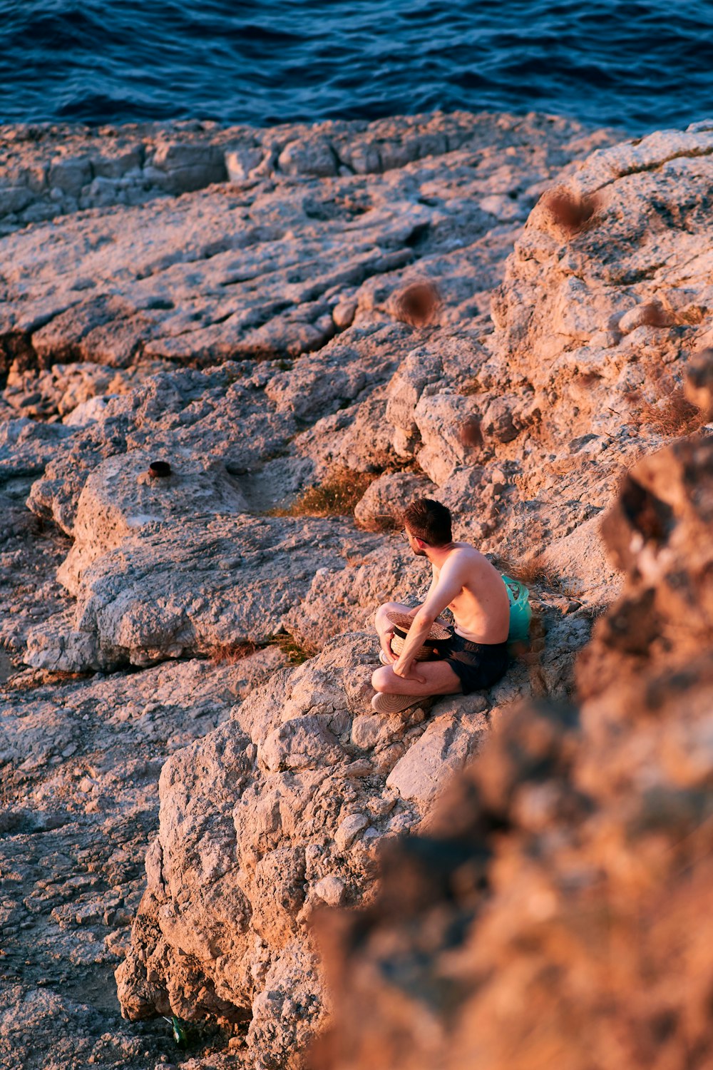 a man sitting on a rock